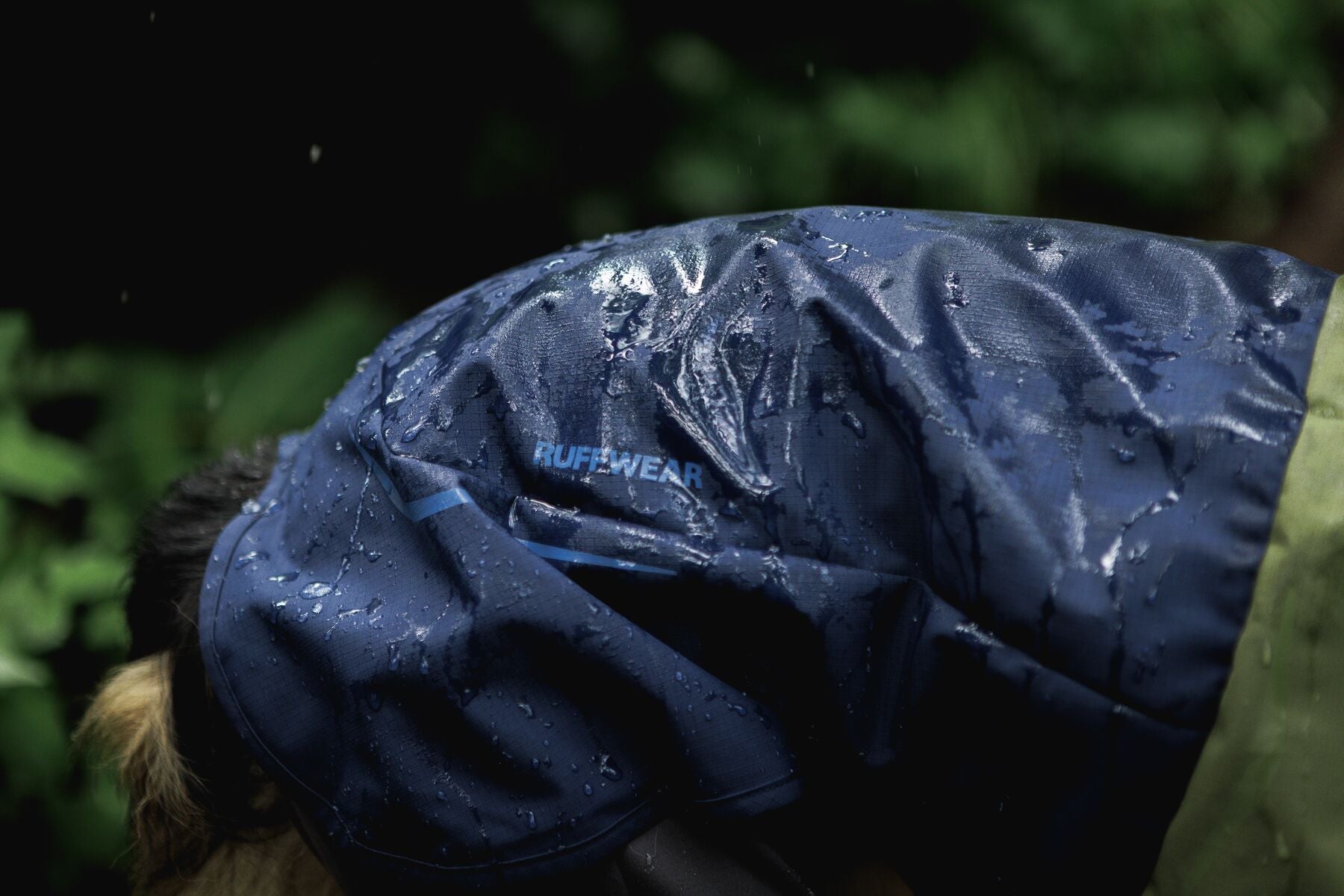 Waterproof Ruffwear Sun Shower dog raincoat with stretch sleeves and a chest zipper for full weatherproof protection