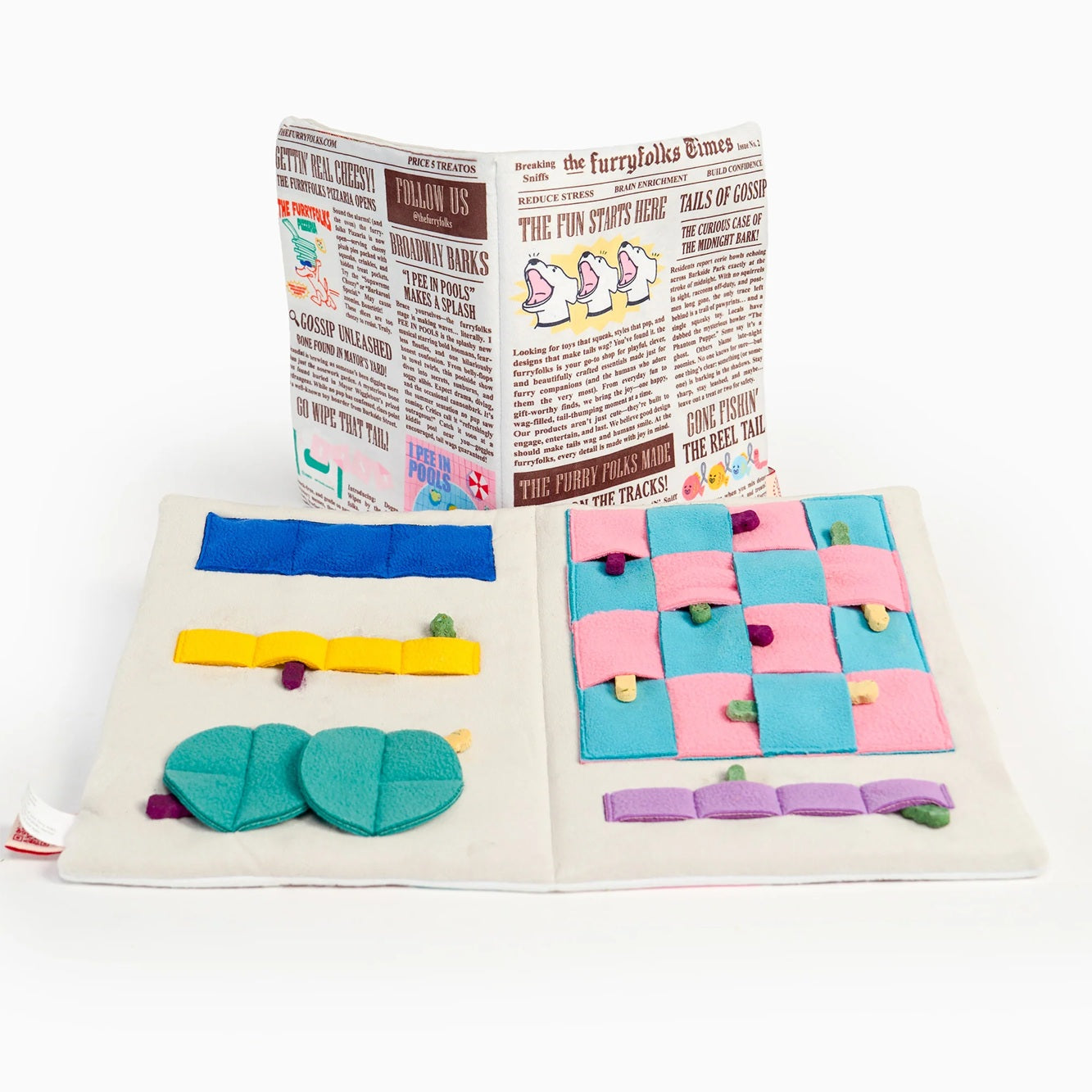Squeaky newspaper-shaped soft toy for dogs, designed for interactive sniffing and treat hunting.