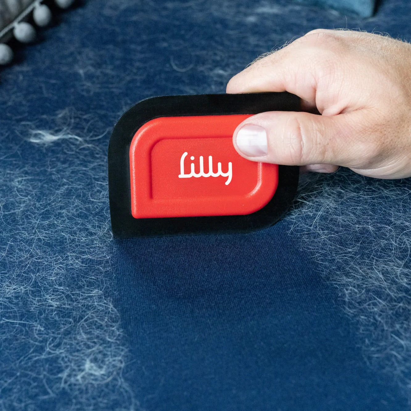 Mini-Blade pet hair detailer tool for removing stubborn fur from fabric surfaces.