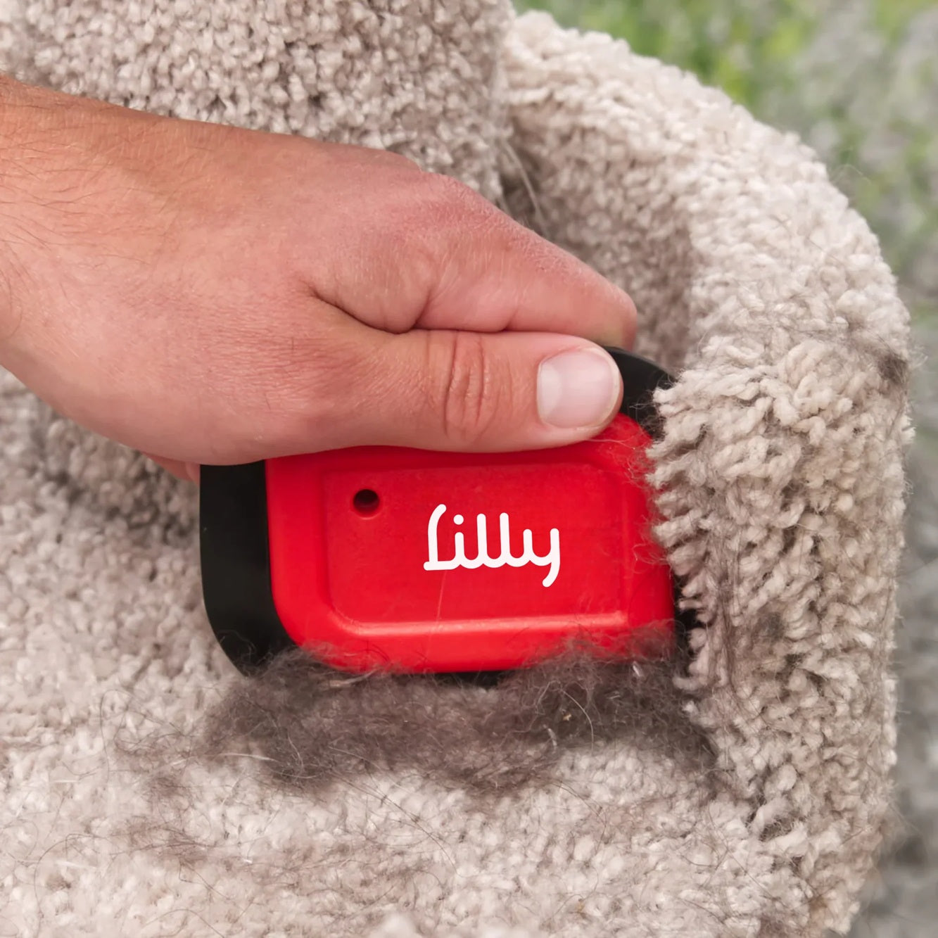 Mini-Blade pet hair detailer tool for removing stubborn fur from fabric surfaces.