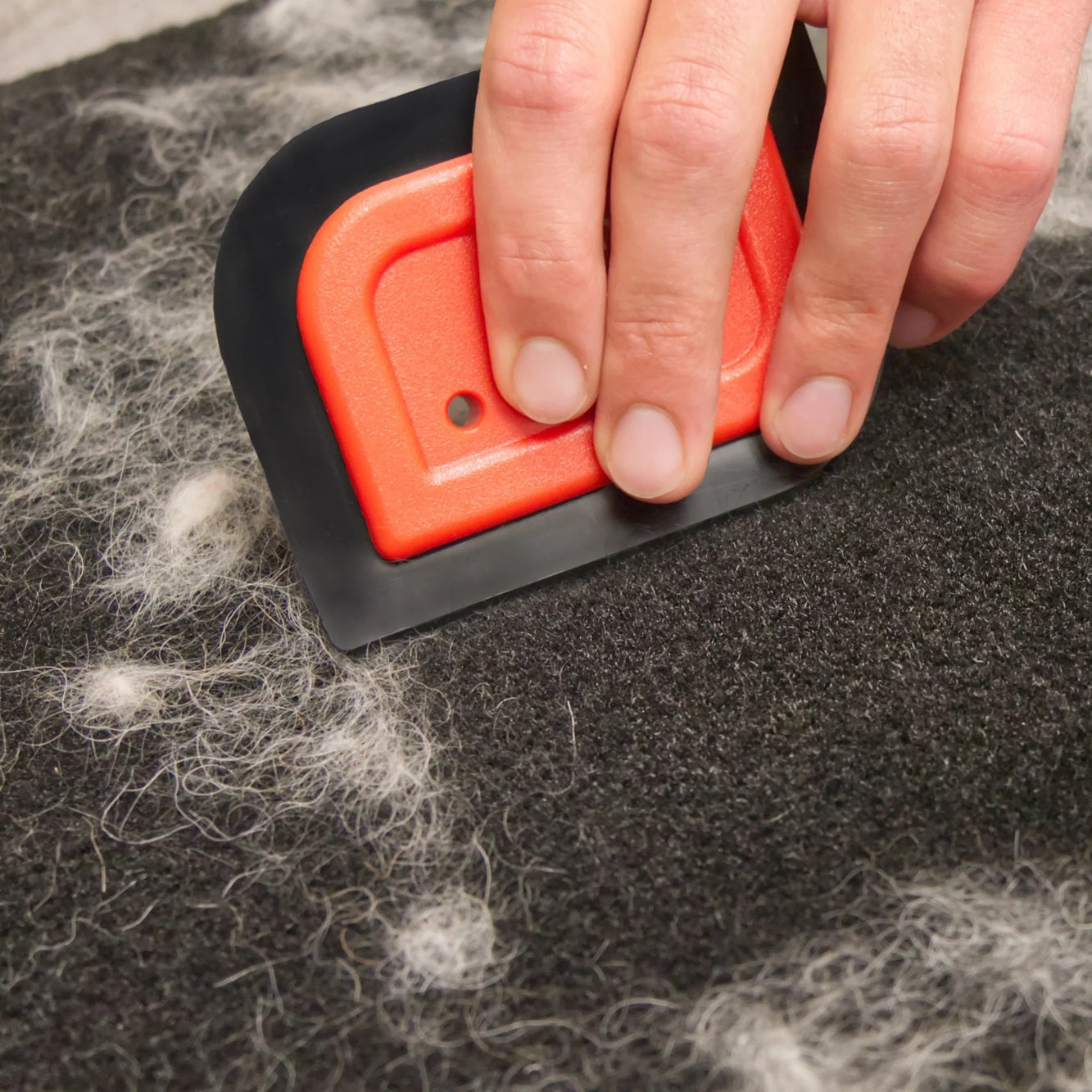 Mini-Blade pet hair detailer tool for removing stubborn fur from fabric surfaces.